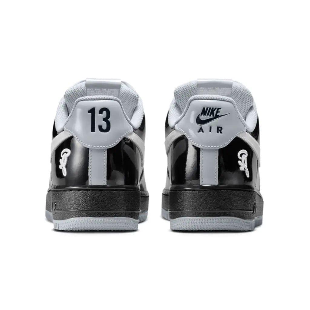 Black and white sneakers with visible branding on a white background